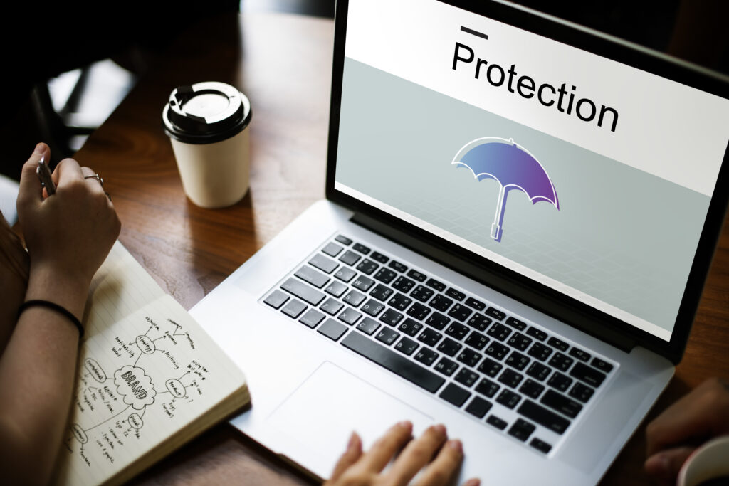 Image of laptop with an image of an umbrella saying protection over the top of it